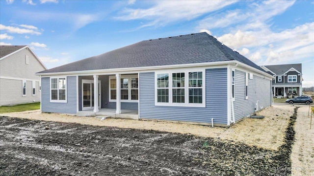 back of property with a patio