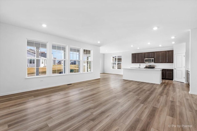 unfurnished living room with light hardwood / wood-style flooring