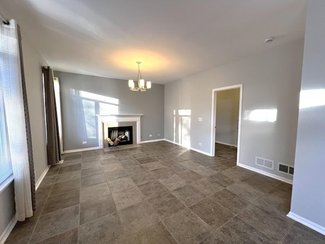 unfurnished living room with a chandelier