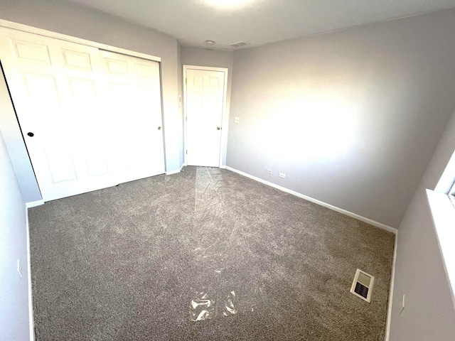 unfurnished bedroom with carpet floors and a closet