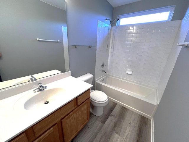 full bathroom featuring hardwood / wood-style flooring, shower / bathtub combination, vanity, and toilet