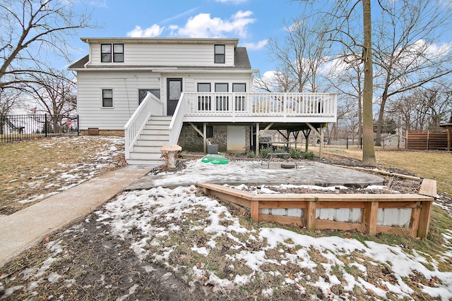 snow covered property with a wooden deck