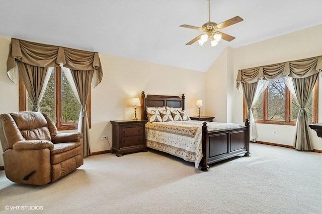 bedroom with vaulted ceiling, light colored carpet, and ceiling fan