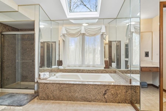 bathroom featuring tile patterned flooring, a skylight, and separate shower and tub