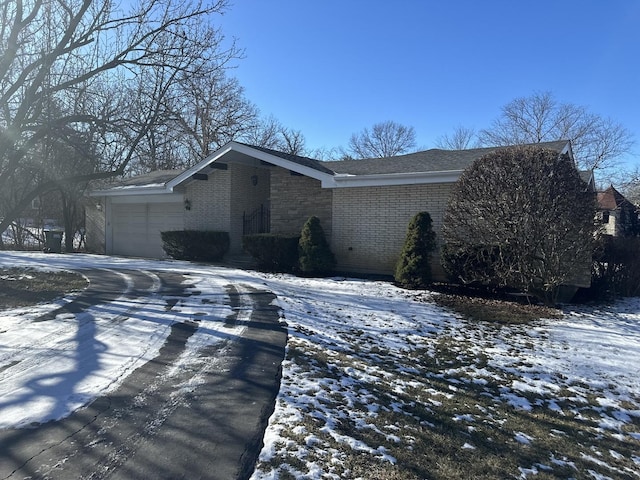 view of snowy exterior with a garage