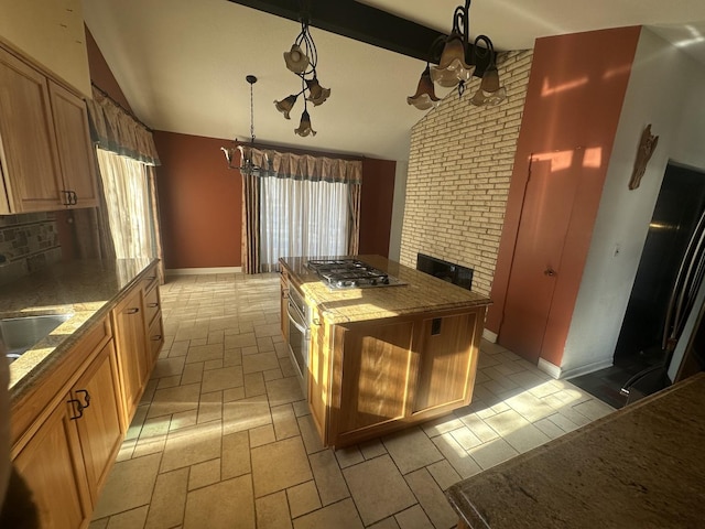 kitchen with stainless steel gas cooktop, vaulted ceiling with beams, an inviting chandelier, decorative light fixtures, and a kitchen island