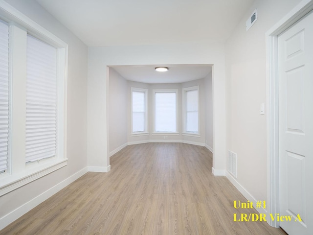 unfurnished room with light hardwood / wood-style floors