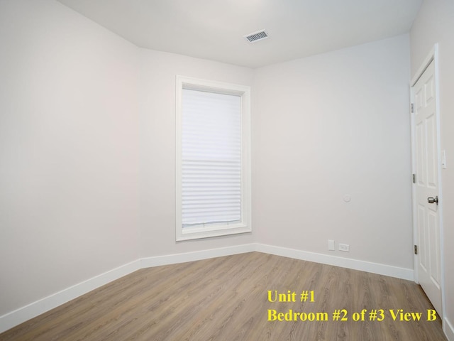 unfurnished room with light wood-type flooring