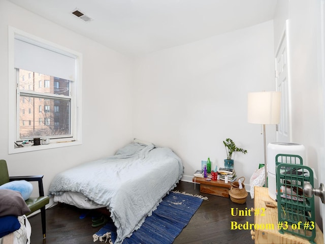 bedroom with hardwood / wood-style flooring