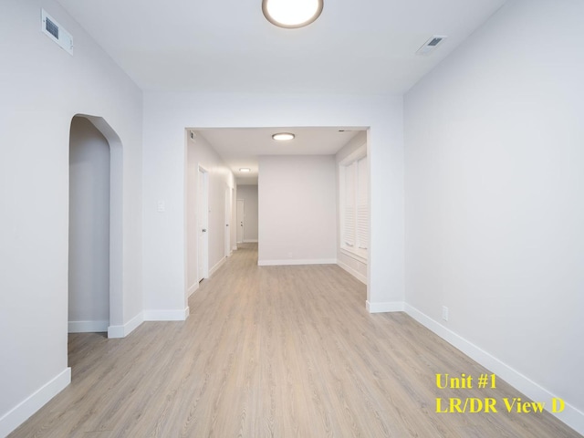 hallway with light hardwood / wood-style floors