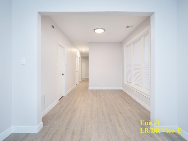 hallway with light hardwood / wood-style flooring