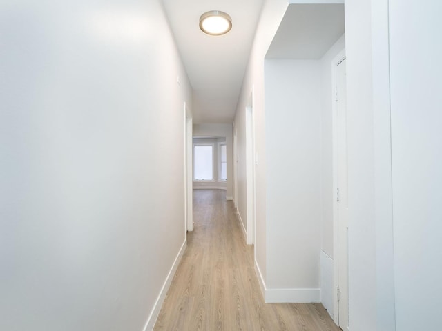 corridor with light hardwood / wood-style flooring