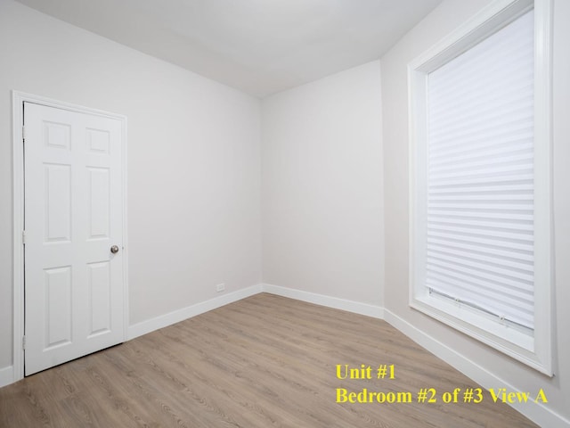 unfurnished room with light hardwood / wood-style flooring