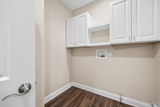 laundry room featuring dark wood-type flooring, cabinets, and washer hookup