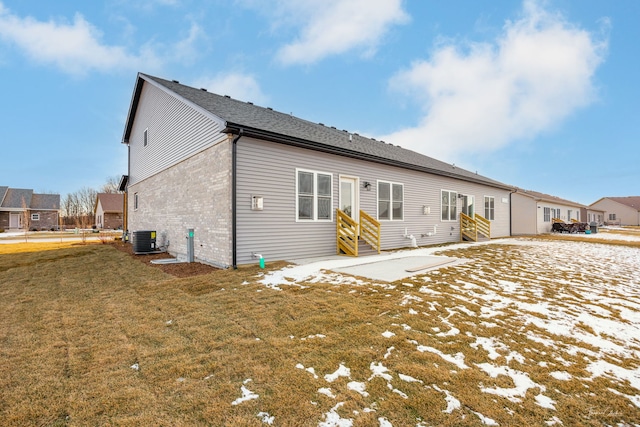 rear view of property with central AC, a yard, and a patio