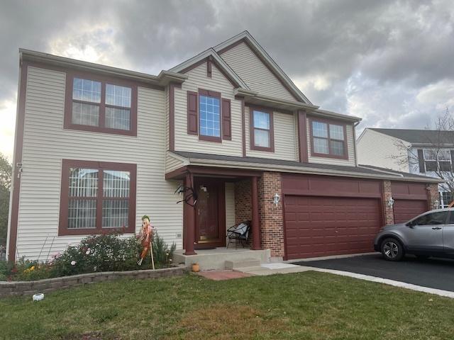 view of front of house with a garage and a front yard