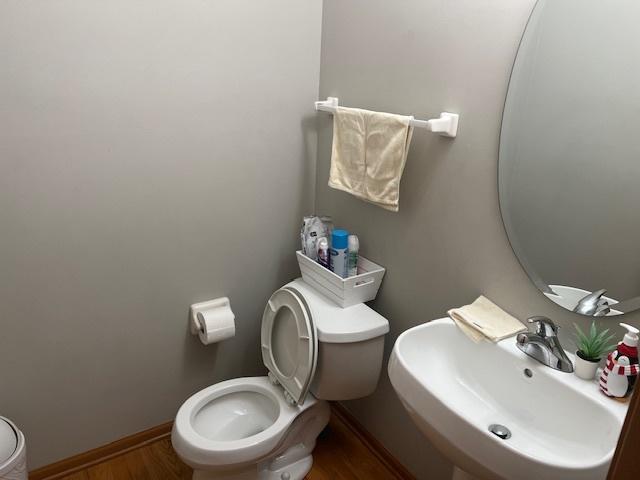 bathroom with sink, hardwood / wood-style flooring, and toilet