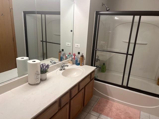 bathroom with vanity, tile patterned floors, and shower / bath combination with glass door