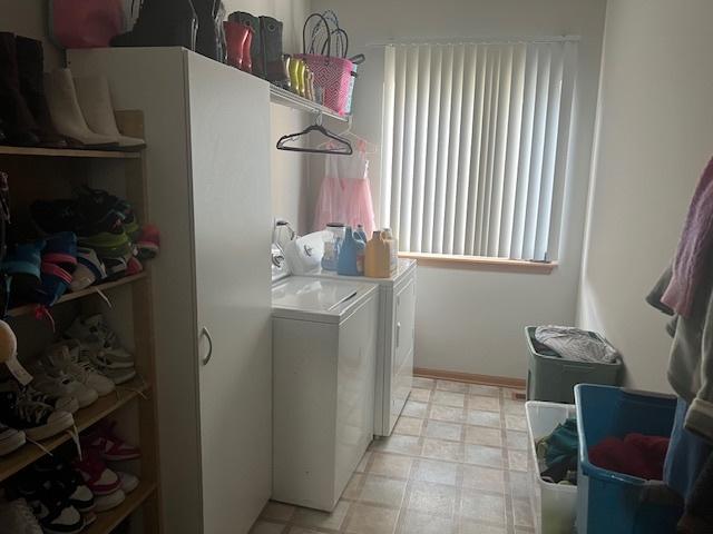 clothes washing area with washer and dryer