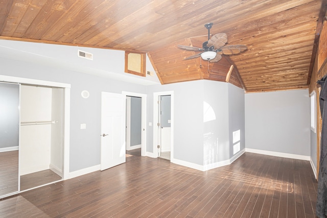 unfurnished living room featuring vaulted ceiling, a barn door, wooden ceiling, and dark hardwood / wood-style flooring