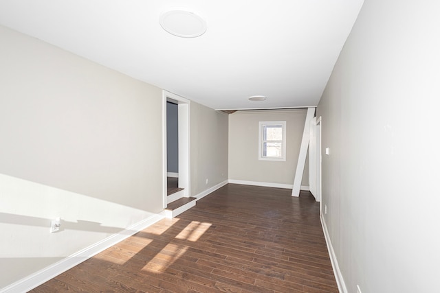 spare room featuring dark wood-type flooring