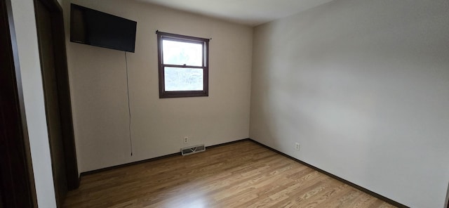 unfurnished room with visible vents and light wood finished floors