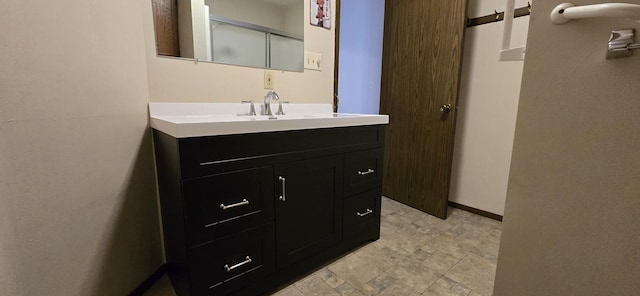 bathroom with baseboards and vanity