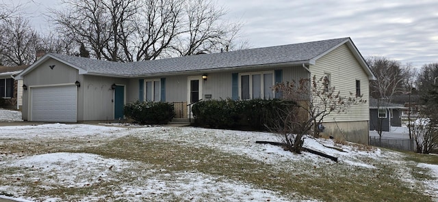 ranch-style home featuring a chimney, brick siding, roof with shingles, and an attached garage