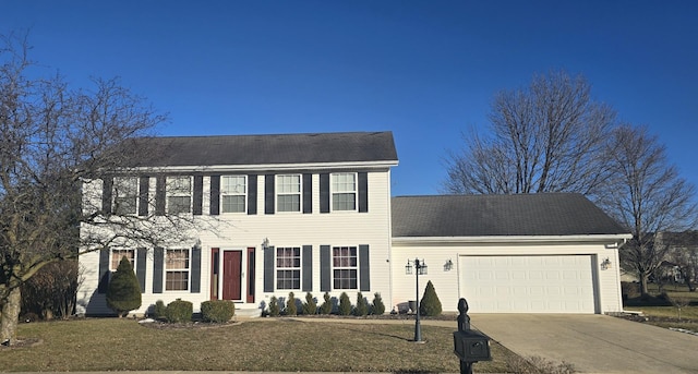 colonial house featuring a garage and a front yard