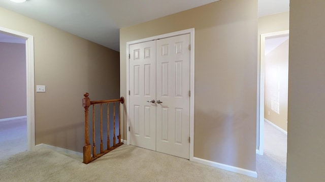 corridor with light colored carpet