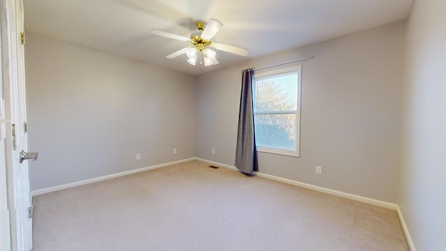 unfurnished room with ceiling fan and light colored carpet