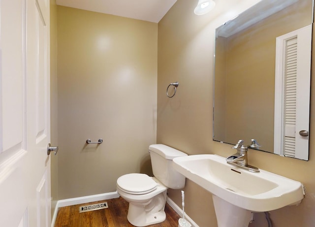 bathroom with sink, wood-type flooring, and toilet