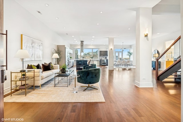 living room featuring hardwood / wood-style flooring and decorative columns