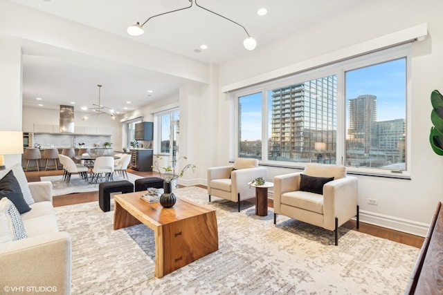 living room featuring a chandelier and light hardwood / wood-style flooring