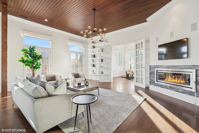 living room with french doors, crown molding, and dark hardwood / wood-style flooring