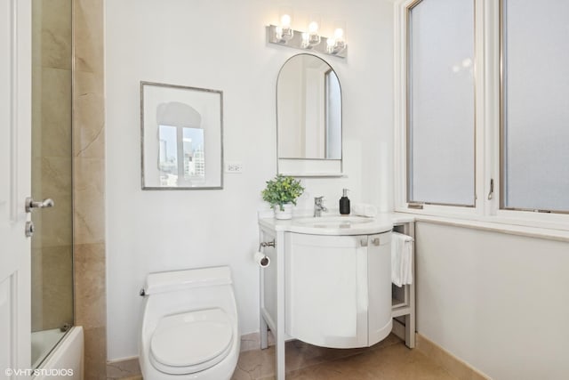 full bathroom featuring vanity, toilet, tile patterned flooring, and combined bath / shower with glass door