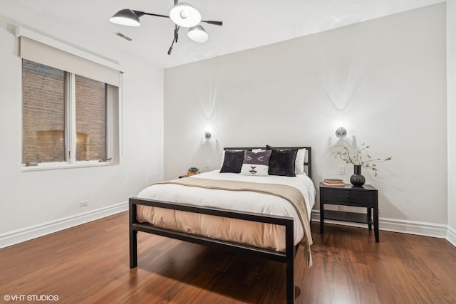 bedroom with dark wood-type flooring and ceiling fan