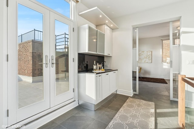 interior space featuring tile patterned flooring, sink, and french doors