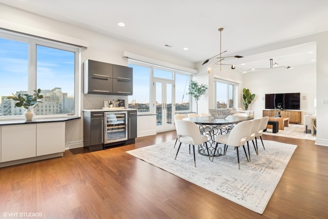 dining area featuring dark hardwood / wood-style floors, beverage cooler, and french doors