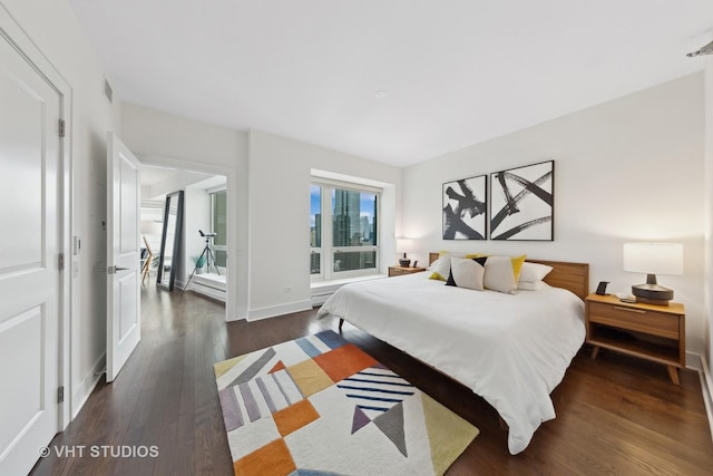 bedroom with dark wood-type flooring