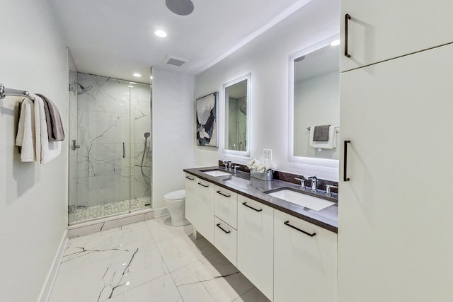 bathroom featuring vanity, toilet, and walk in shower