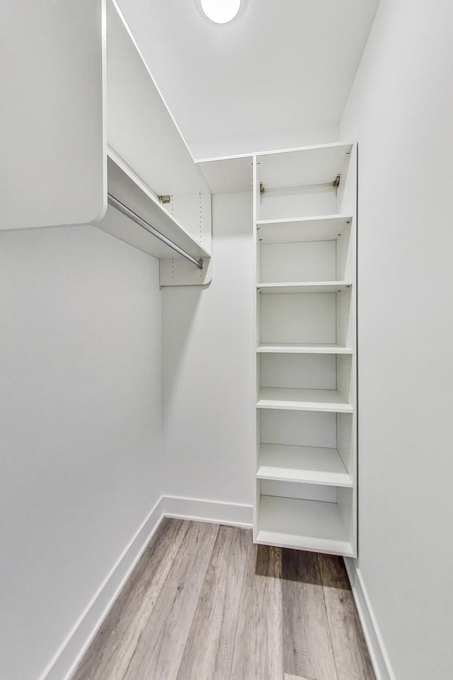 spacious closet with light hardwood / wood-style floors