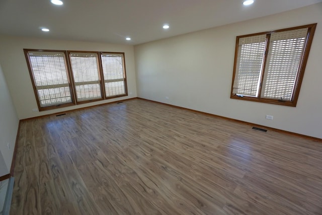 spare room with hardwood / wood-style flooring and a wealth of natural light