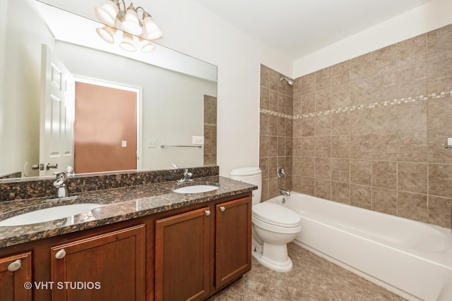 full bathroom with vanity, tile patterned flooring, toilet, and tiled shower / bath