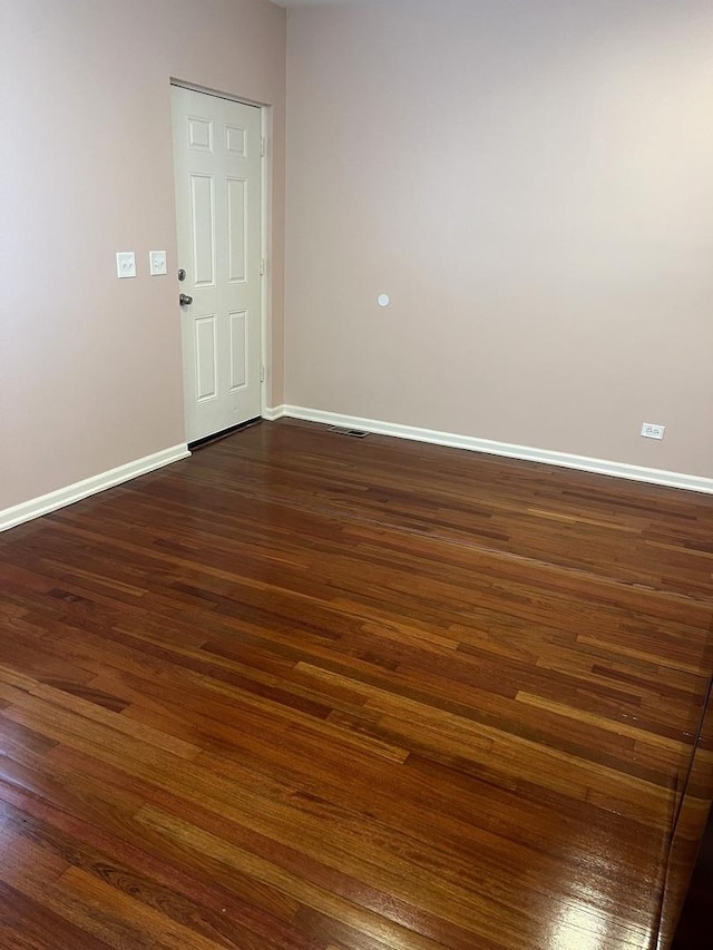 empty room featuring dark hardwood / wood-style flooring