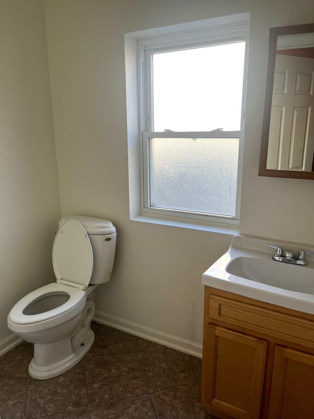 bathroom with tile patterned flooring, vanity, and toilet