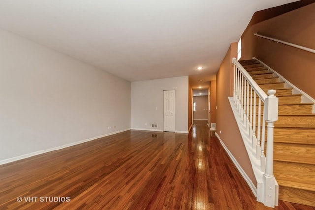 unfurnished living room featuring dark hardwood / wood-style floors