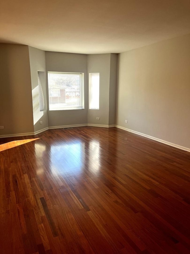 spare room with dark hardwood / wood-style floors