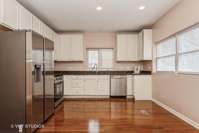 kitchen featuring stainless steel appliances, white cabinetry, and sink