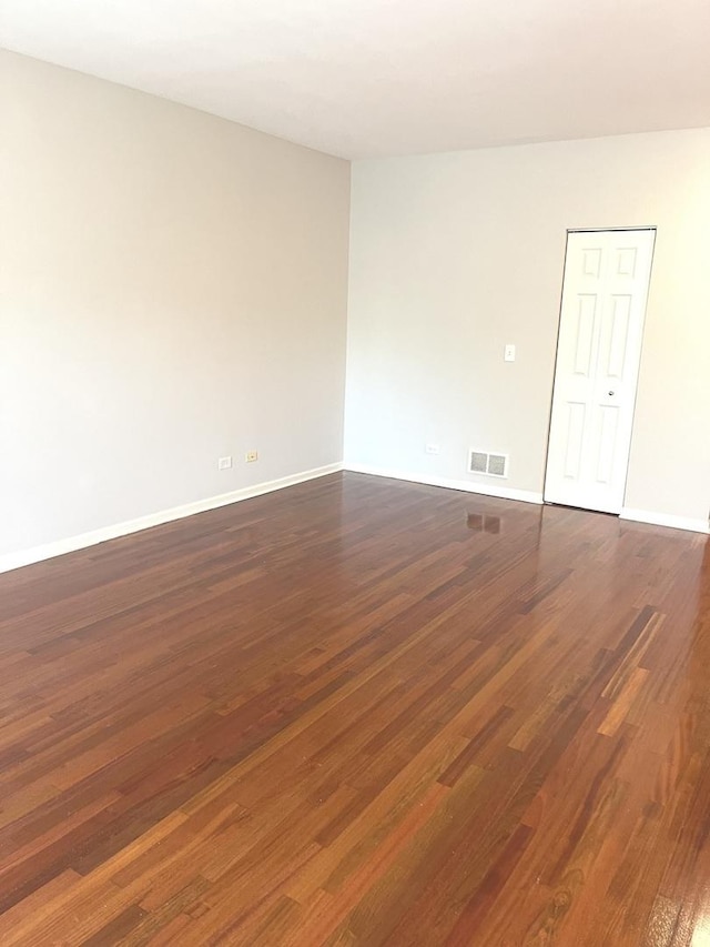 spare room with dark hardwood / wood-style flooring